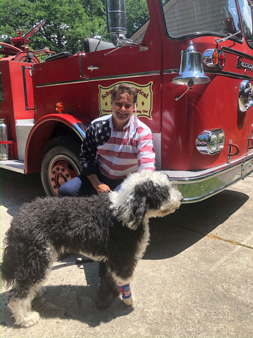 Rep. Tim Twardzik and his dog, Watson, in front of a fire engine preserved by the Schuylkill Historical Fire Society, honoring local fire and EMS personnel. 
